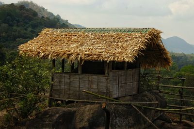 Traditional house on field against sky