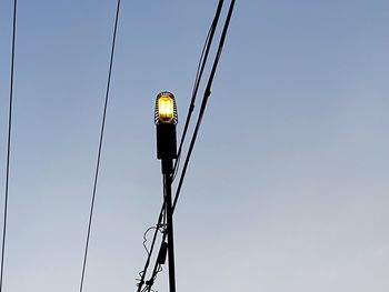 Low angle view of lighting equipment against sky