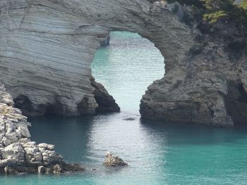 Idyllic shot of rock archway in sea