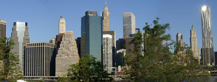 Low angle view of skyscrapers against clear sky