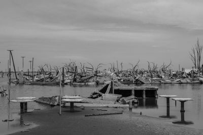 Boats moored at harbor against sky