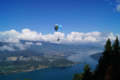 Person paragliding above river