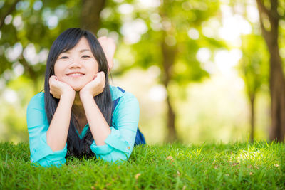 Portrait of a smiling young woman on field