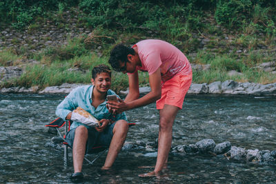 Full length of father and daughter in water