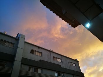 Low angle view of building against sky during sunset