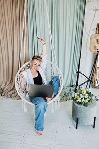 Hipster woman blogger working with laptop in studio. modern girl creator with laptop