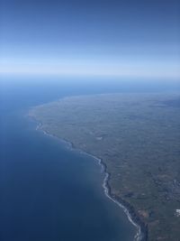 Scenic view of sea against blue sky