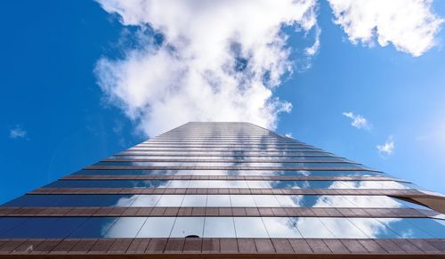 Low angle view of building against cloudy sky