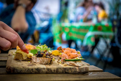 Cropped image of person preparing food on table
