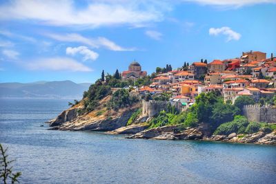 Townscape by sea against sky