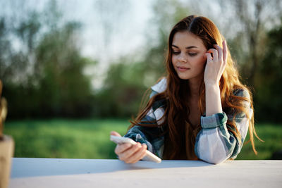 Young woman using mobile phone