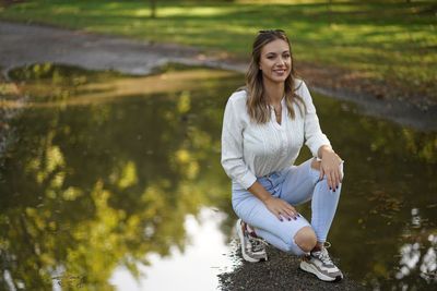 Portrait of smiling woman sitting in lake