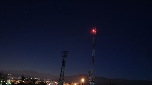 Low angle view of illuminated lights against sky at night