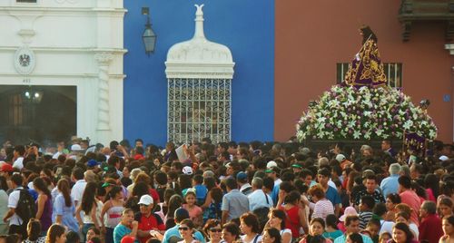 Crowd outside temple against sky