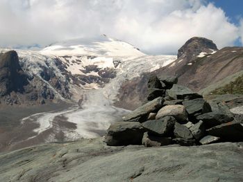 Scenic view of mountains against cloudy sky