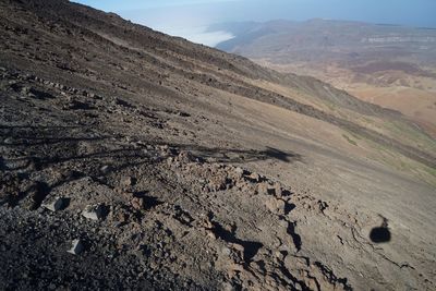 Aerial view of land and mountains against sky
