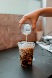 Cropped hand of man holding drink