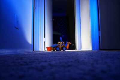 Toy bulldozer on rug at home