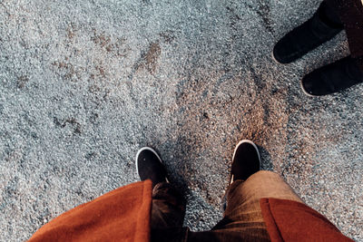 Low section of person standing on road