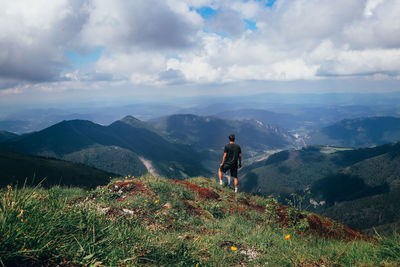 Athlete in a black t-shirt poses on top of the mala fatra mountain. climbing mount hromova. a hiker