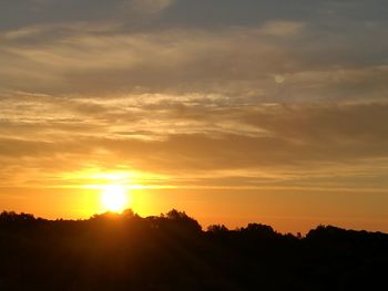 Silhouette landscape against scenic sky