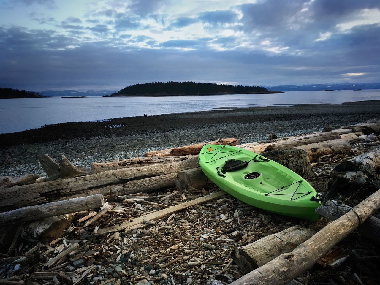 BOAT MOORED ON SHORE AGAINST SKY