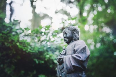 Low angle view of statue against trees