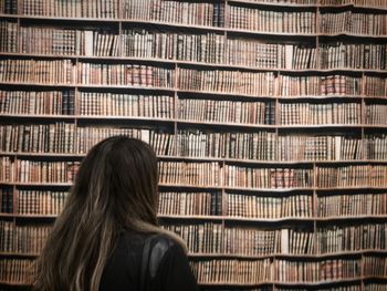 Rear view of woman reading book