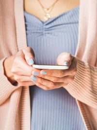 Midsection of woman using mobile phone