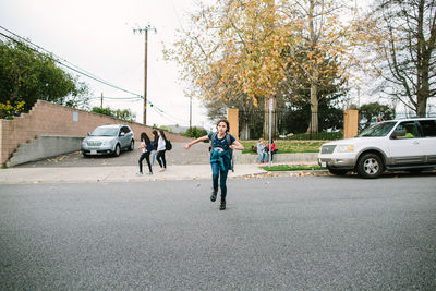 Girl runs across street toward car after school