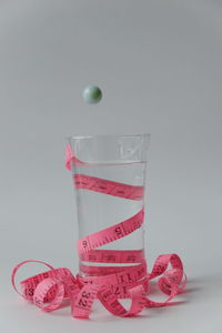 Close-up of pink glass against white background