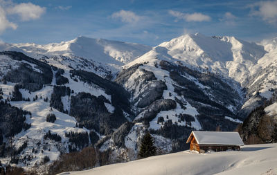 Scenic view of snow covered mountains against sky