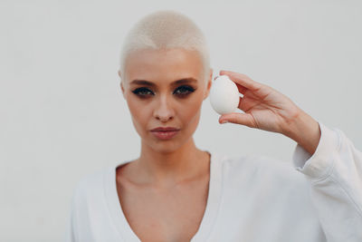 Portrait of young woman holding white background