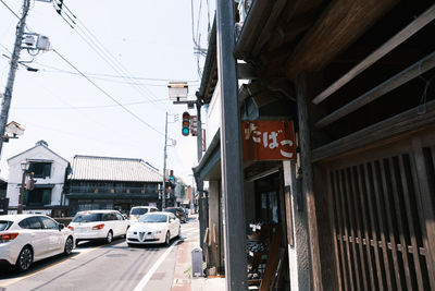 Vehicles on road amidst buildings in city