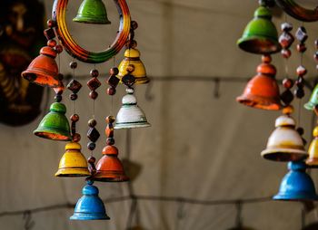 Low angle view of colorful decorations hanging against wall