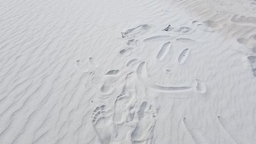 High angle view of footprints on sand at beach