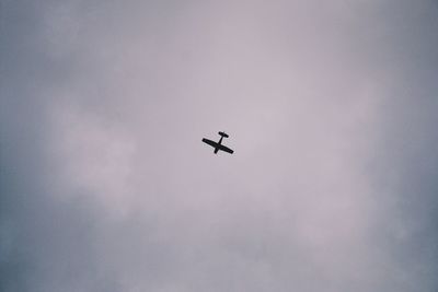 Low angle view of airplane flying in sky