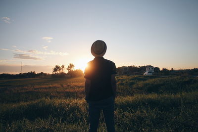 Silhouette of woman standing on field