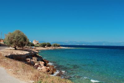 Scenic view of sea against clear blue sky