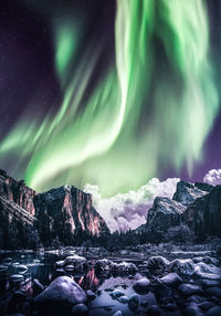 Scenic view of snowcapped mountains against sky at night