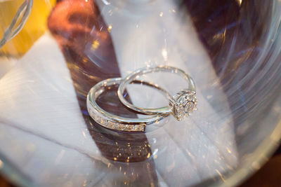 Close-up of wedding rings on glass