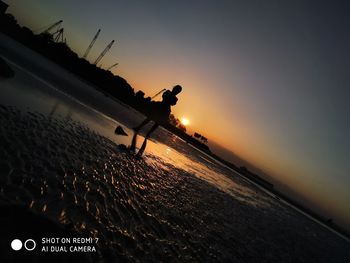 Scenic view of beach against sky during sunset