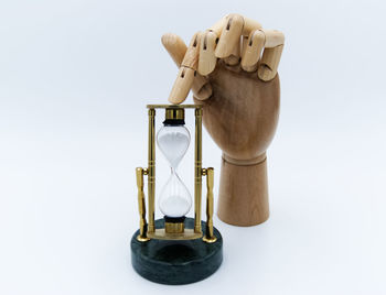 Close-up of clock on table against white background