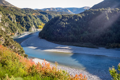 Scenic view of river amidst mountains against sky