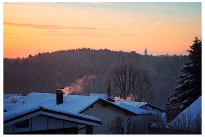 Houses against sky during winter