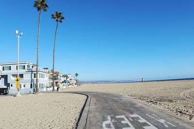 Scenic view of beach against clear blue sky