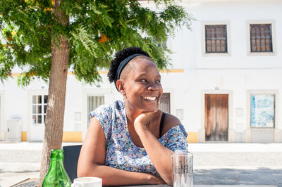Portrait of smiling woman sitting outdoors