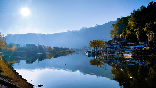 Scenic view of lake by trees against sky