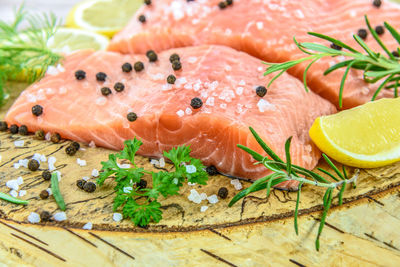 Close-up of salmon steak on wood