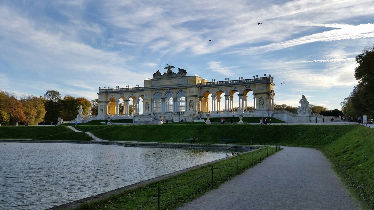 architecture, built structure, building exterior, sky, history, famous place, travel destinations, cloud - sky, grass, tourism, architectural column, incidental people, travel, facade, tree, lawn, arch, palace, dome, cloud